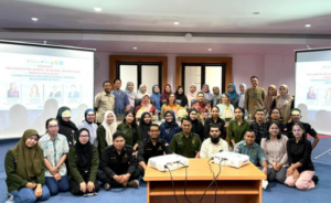 Large group posing in conference room with projectors