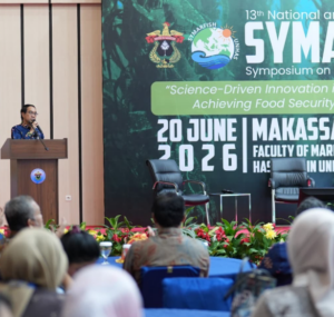 Speaker at national symposium stage in Makassar