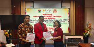 Three officials holding certificates at exchange program event