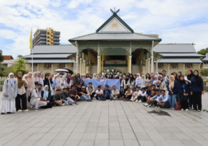 Large group posing in front of ornate mosque