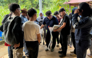 Group examining equipment during outdoor demonstration