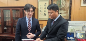 Two men in suits reviewing a document in office