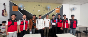 Group of students in red vests classroom