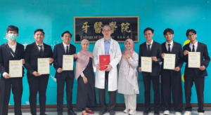 Doctor and students holding certificates at dental college