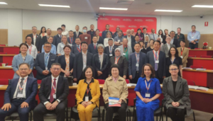 Large international group posing in lecture hall