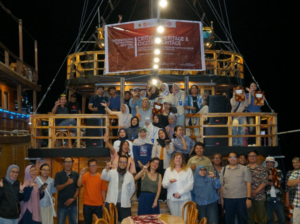 Group photo on boat under digital heritage banner