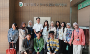 Group of students posing at Japanese university entrance