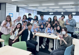 Group of students posing with finger hearts indoors