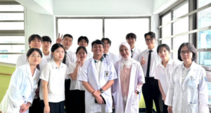 Group of students in lab coats indoors