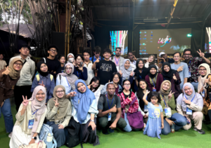 Large group posing at indoor event stage