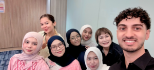 Smiling group of seven people posing for a selfie