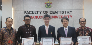 Five men hold certificates at Hasanuddin University dentistry faculty