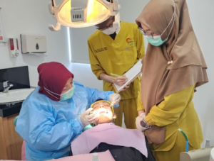 Dental team treating patient in clinic