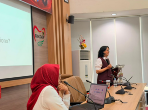 Woman speaking at podium during conference presentation
