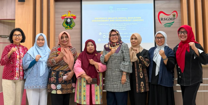 Seven women pose at Universiti Malaya dental education event.