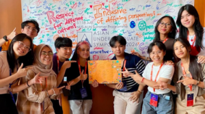 Students pose with artwork at Asian undergraduate symposium