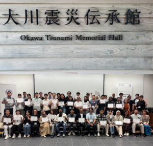 Group holding certificates at Okawa Tsunami Memorial Hall