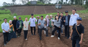 Group posing in a cultivated hillside field