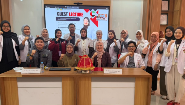 Guest lecture participants pose with raised fists