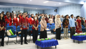 Audience standing in auditorium during formal event