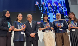 Six award recipients pose with trophies onstage.