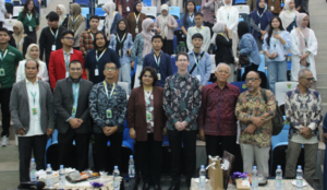 Officials and attendees pose at auditorium event
