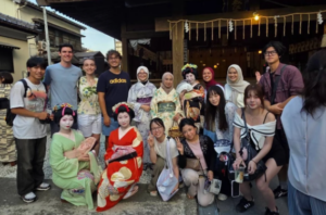 Diverse group poses with women in traditional Japanese kimono