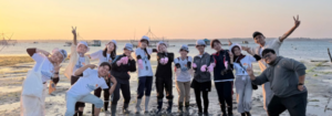 Group posing on tidal flats at sunset