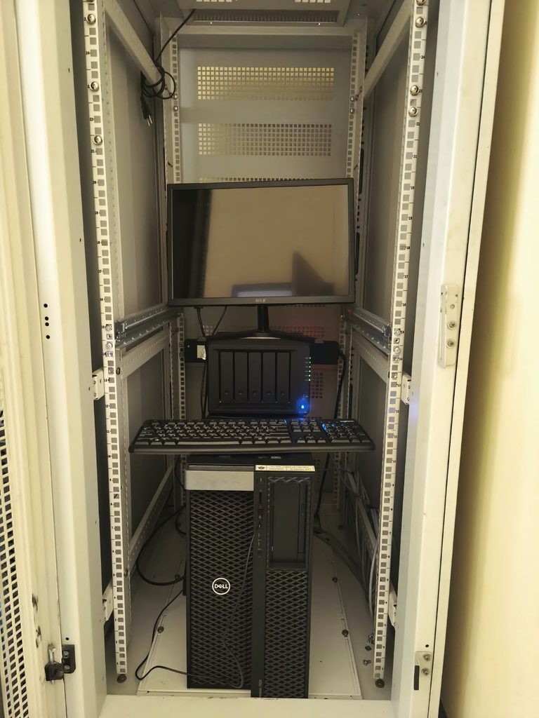 Server rack with monitor, keyboard, storage device, and Dell tower