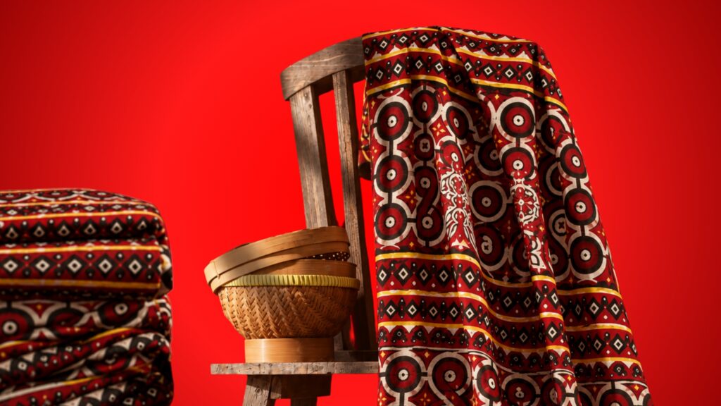 Patterned textile draped over wooden chair with woven basket